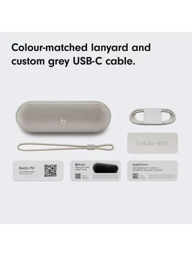 Beats Pill+ with lanyard, custom grey USB-C cable, and accessories on a white background